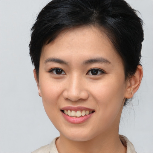 Joyful asian young-adult female with short  brown hair and brown eyes