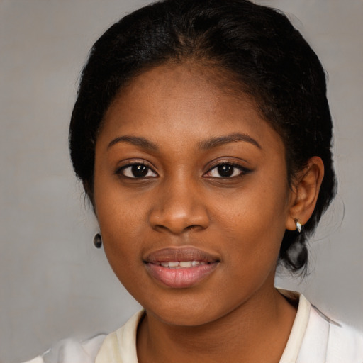 Joyful black young-adult female with medium  brown hair and brown eyes