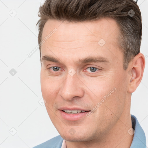 Joyful white adult male with short  brown hair and brown eyes