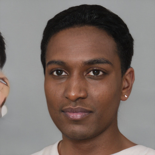 Neutral black young-adult male with short  black hair and brown eyes
