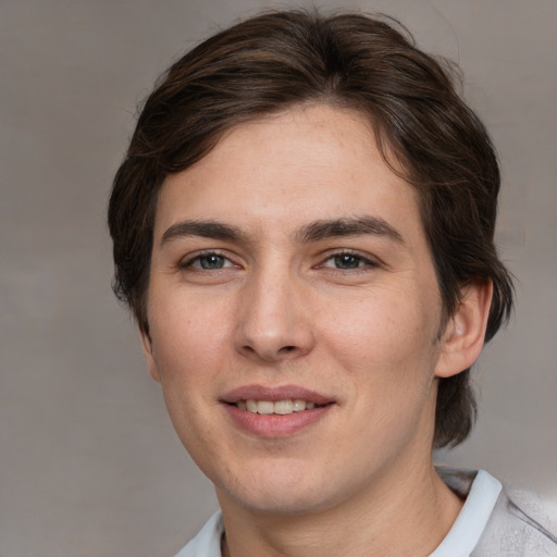 Joyful white young-adult male with medium  brown hair and brown eyes