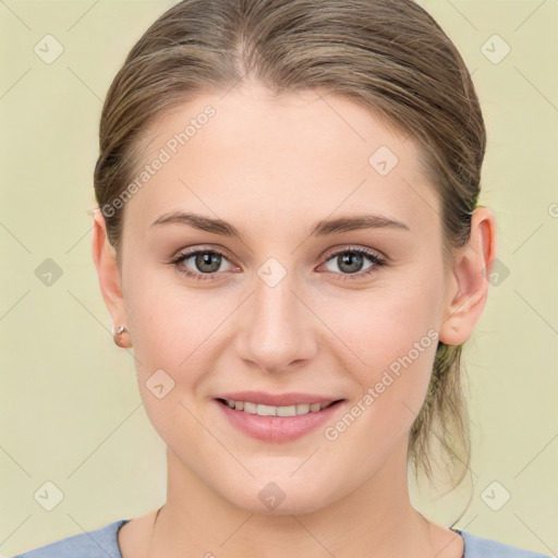 Joyful white young-adult female with medium  brown hair and blue eyes