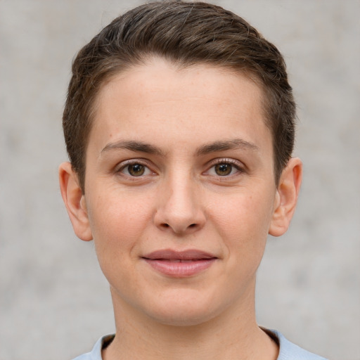 Joyful white young-adult female with short  brown hair and grey eyes