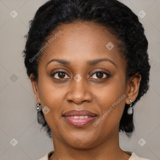 Joyful black adult female with short  brown hair and brown eyes