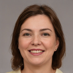 Joyful white adult female with medium  brown hair and brown eyes