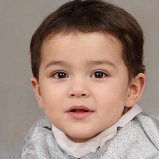 Joyful white child male with short  brown hair and brown eyes