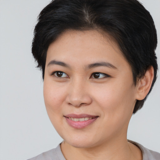 Joyful asian young-adult female with short  brown hair and brown eyes