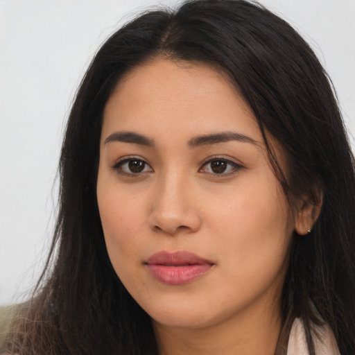 Joyful latino young-adult female with long  brown hair and brown eyes