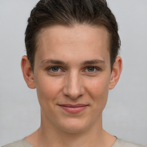 Joyful white young-adult female with short  brown hair and grey eyes