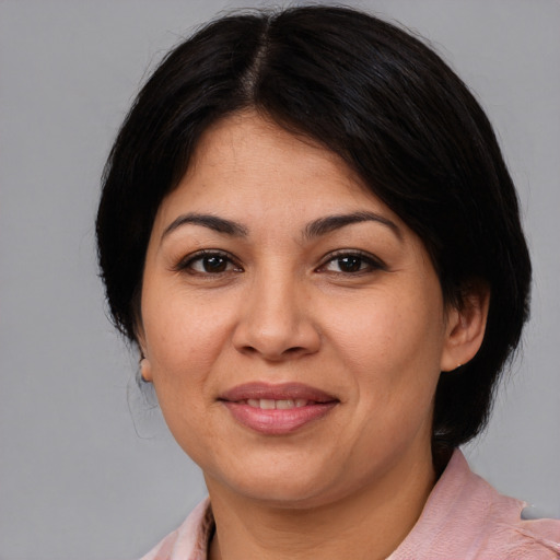 Joyful latino young-adult female with medium  brown hair and brown eyes