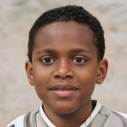 Joyful black child male with short  brown hair and brown eyes