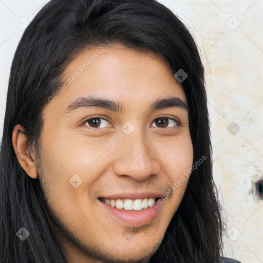 Joyful white young-adult male with long  brown hair and brown eyes