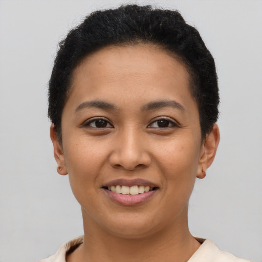 Joyful latino young-adult female with short  brown hair and brown eyes