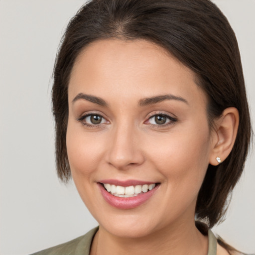 Joyful white young-adult female with medium  brown hair and brown eyes