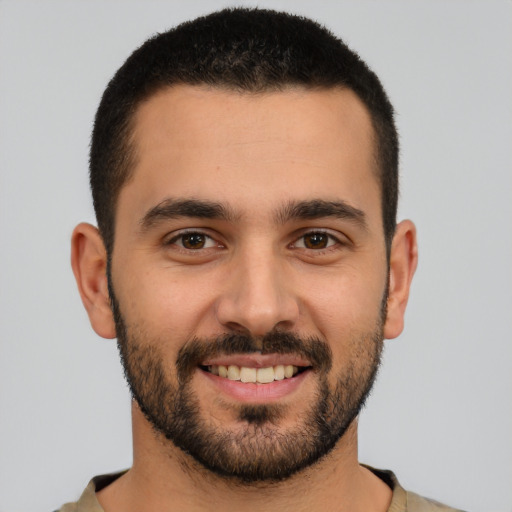 Joyful white young-adult male with short  black hair and brown eyes