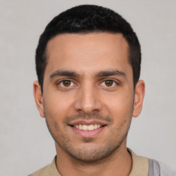 Joyful white young-adult male with short  black hair and brown eyes