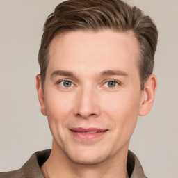 Joyful white young-adult male with short  brown hair and grey eyes