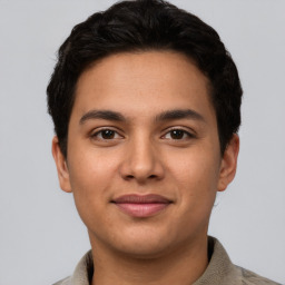 Joyful latino young-adult male with short  brown hair and brown eyes