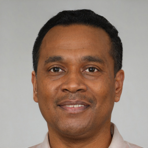 Joyful black adult male with short  black hair and brown eyes