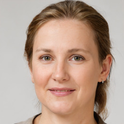 Joyful white adult female with medium  brown hair and grey eyes