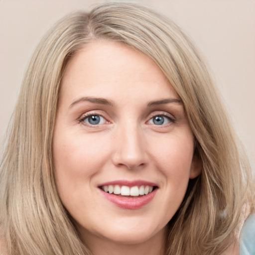 Joyful white young-adult female with long  brown hair and blue eyes