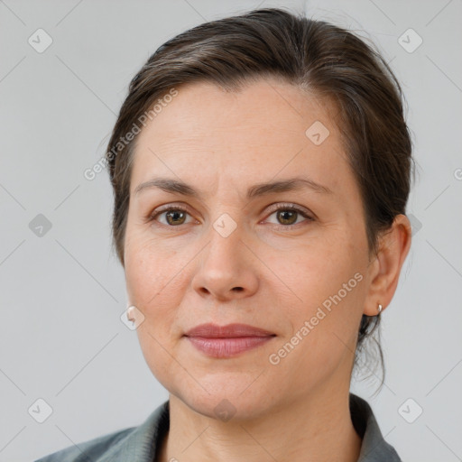 Joyful white adult female with medium  brown hair and brown eyes