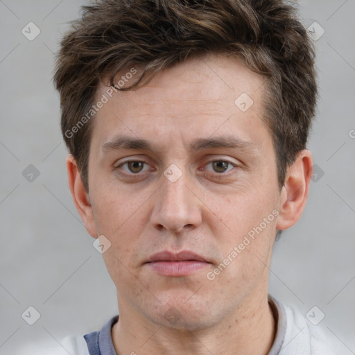 Joyful white adult male with short  brown hair and grey eyes