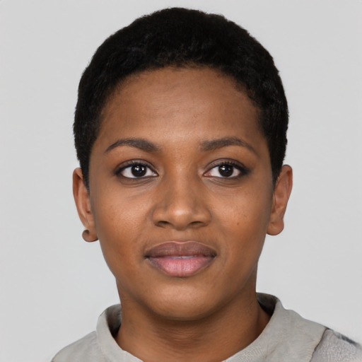 Joyful black young-adult female with short  black hair and brown eyes