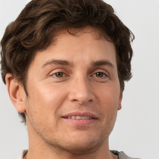 Joyful white adult male with short  brown hair and grey eyes