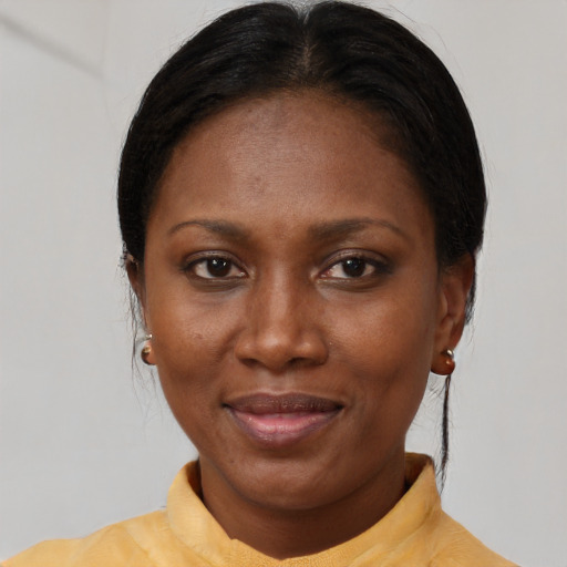 Joyful black adult female with short  brown hair and brown eyes