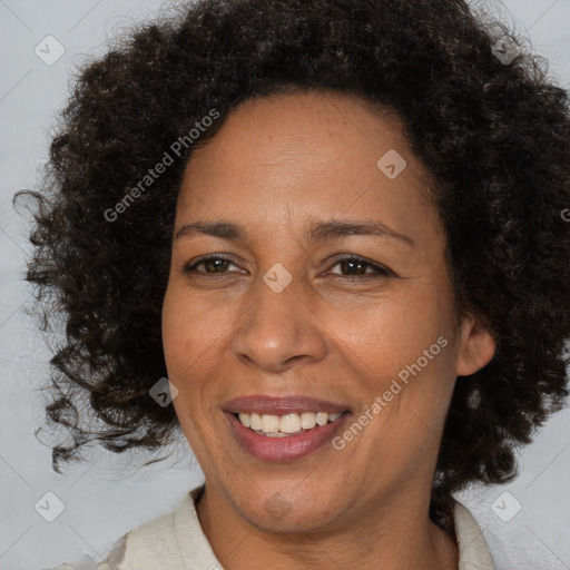 Joyful black adult female with medium  brown hair and brown eyes