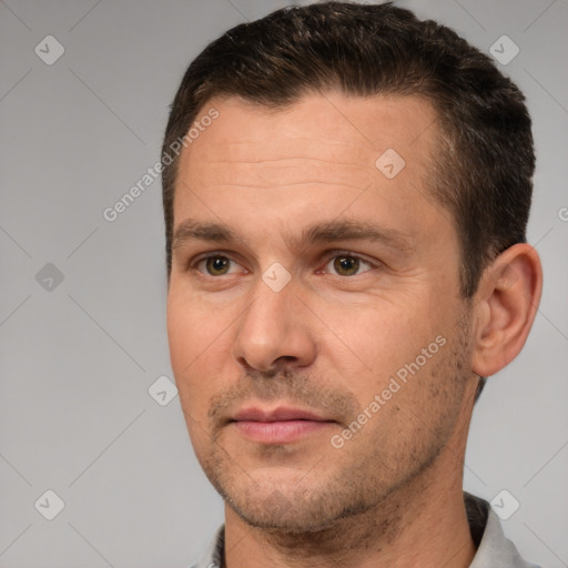 Joyful white adult male with short  brown hair and brown eyes