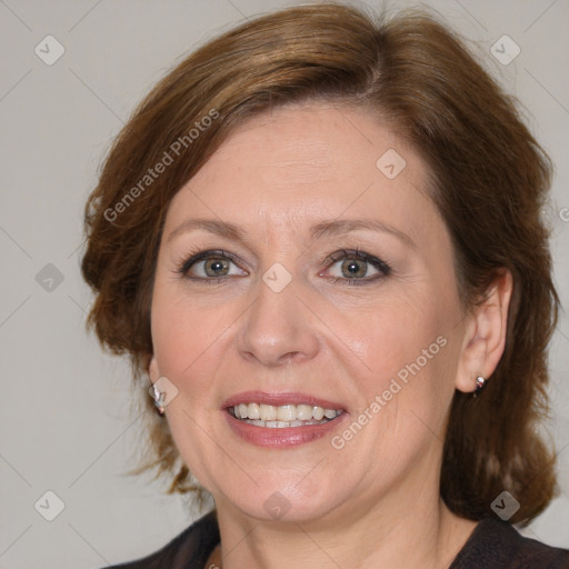 Joyful white adult female with medium  brown hair and blue eyes