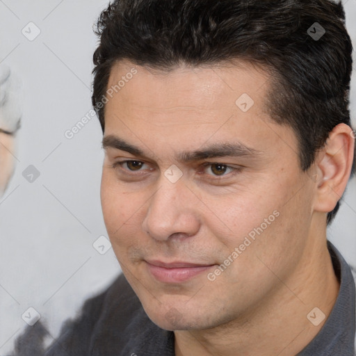 Joyful white young-adult male with short  brown hair and brown eyes