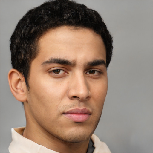 Neutral latino young-adult male with short  brown hair and brown eyes
