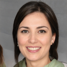 Joyful white young-adult female with medium  brown hair and brown eyes