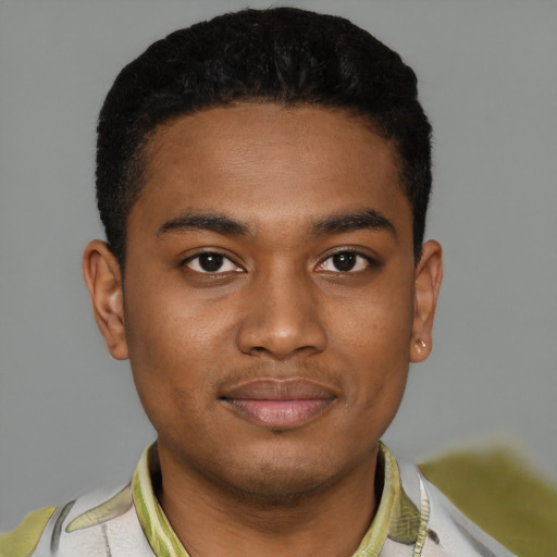 Joyful black young-adult male with short  brown hair and brown eyes
