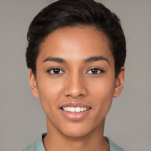 Joyful latino young-adult female with short  brown hair and brown eyes