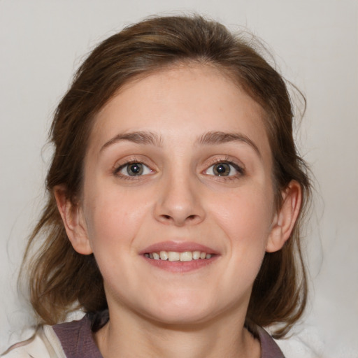 Joyful white young-adult female with medium  brown hair and blue eyes