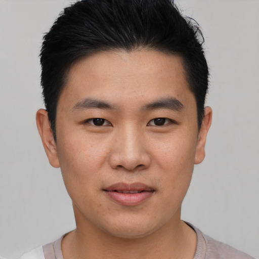 Joyful asian young-adult male with short  black hair and brown eyes