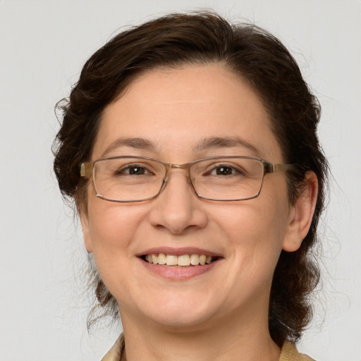 Joyful white adult female with medium  brown hair and grey eyes