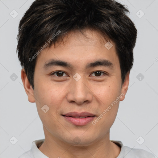 Joyful asian young-adult male with short  brown hair and brown eyes