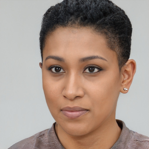 Joyful black young-adult female with short  black hair and brown eyes