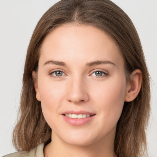 Joyful white young-adult female with long  brown hair and grey eyes