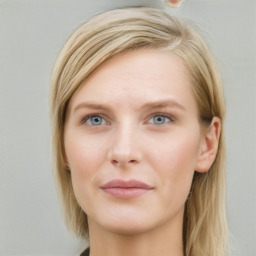 Joyful white young-adult female with long  brown hair and blue eyes