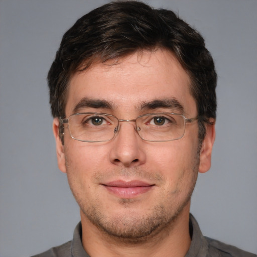 Joyful white adult male with short  brown hair and brown eyes