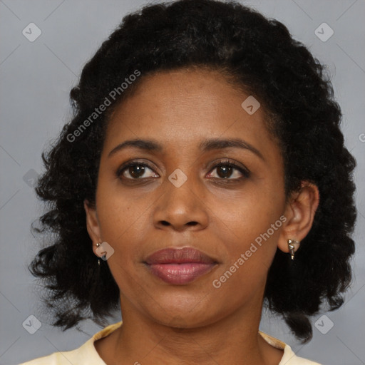 Joyful black adult female with medium  brown hair and brown eyes