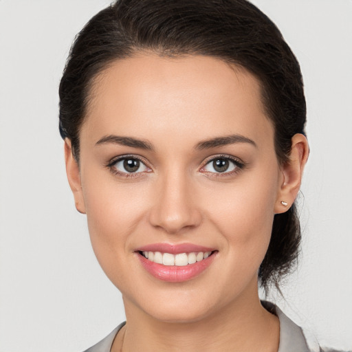 Joyful white young-adult female with medium  brown hair and brown eyes