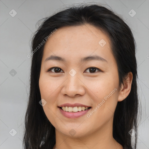 Joyful asian young-adult female with long  brown hair and brown eyes