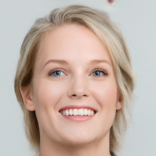 Joyful white young-adult female with medium  brown hair and blue eyes